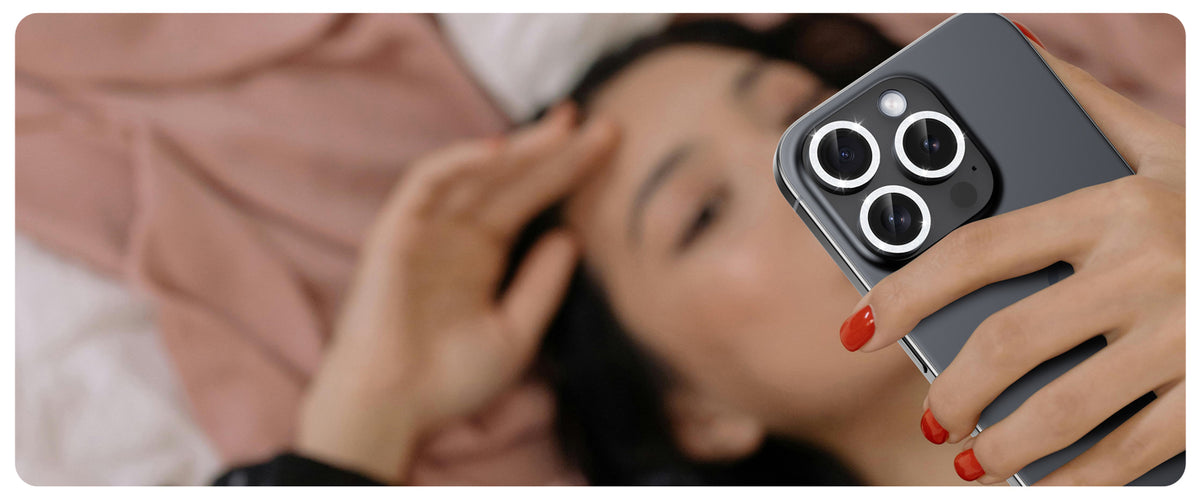 iPhone with black UARMOR camera lens protector in everyday use