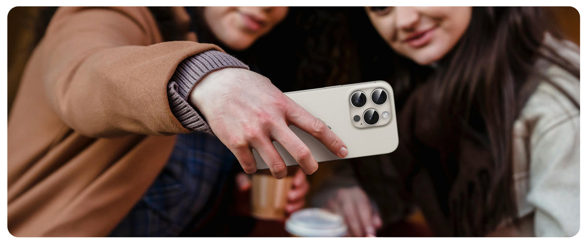 Friends taking a photo with an iPhone protected by a UARMOR lens protector